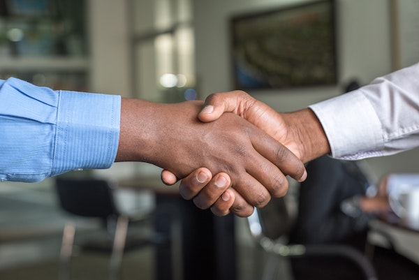 Businessman handshake representing a purchase agreement apostille