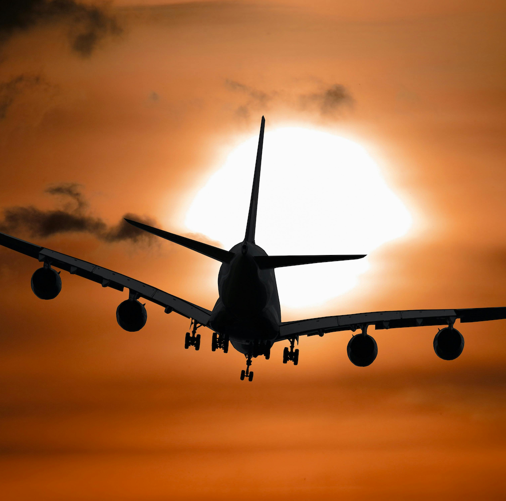 Airplane heading into the sunset, representing a Golden Visa apostille